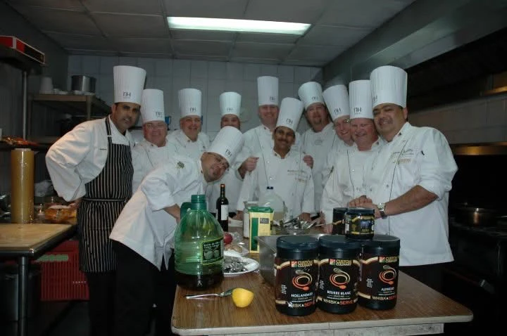 Chef Mike Minor with group of chefs in the kitchen