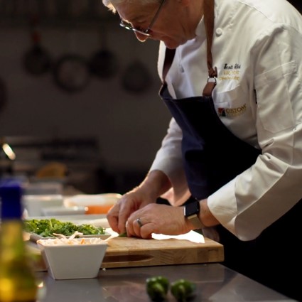 Chef neatly preparing a dish in kitchen